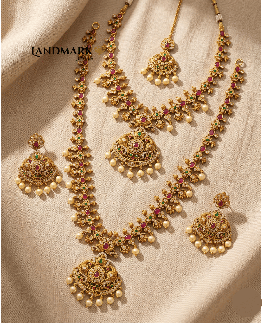 landmark-jewels-bridal-jewelry-set-featuring-long-and-short-antique-gold-necklaces-earrings-and-maang-tikka-with-red-green-stones-and-pearls