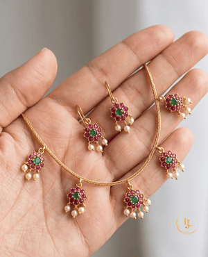 Detailed view of the Landmark Jewels floral pendant necklace and earrings set showcasing the gold-plated twisted chain.