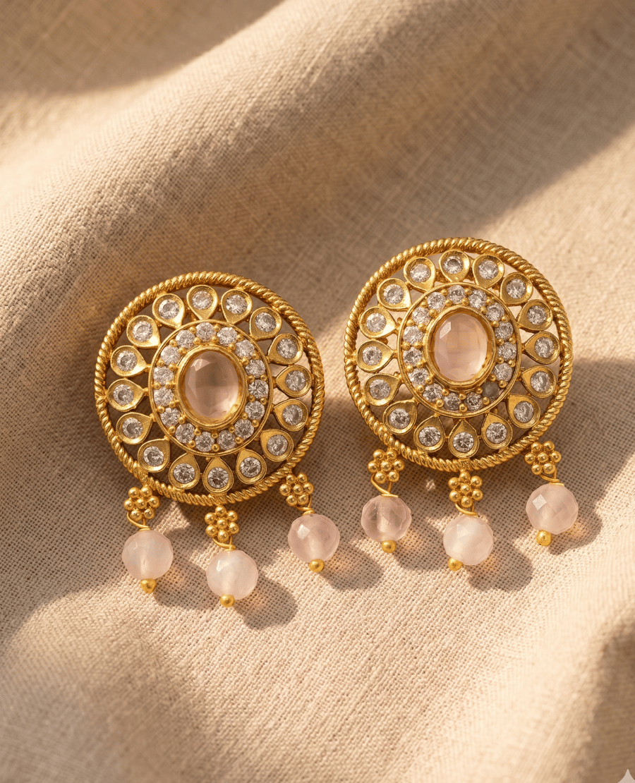 round-vintage-style-gold-earrings-with-a-central-oval-rose-quartz-stone-surrounded-by-cz-accents-and-hanging-pink-quartz-beads-by-landmark-jewels