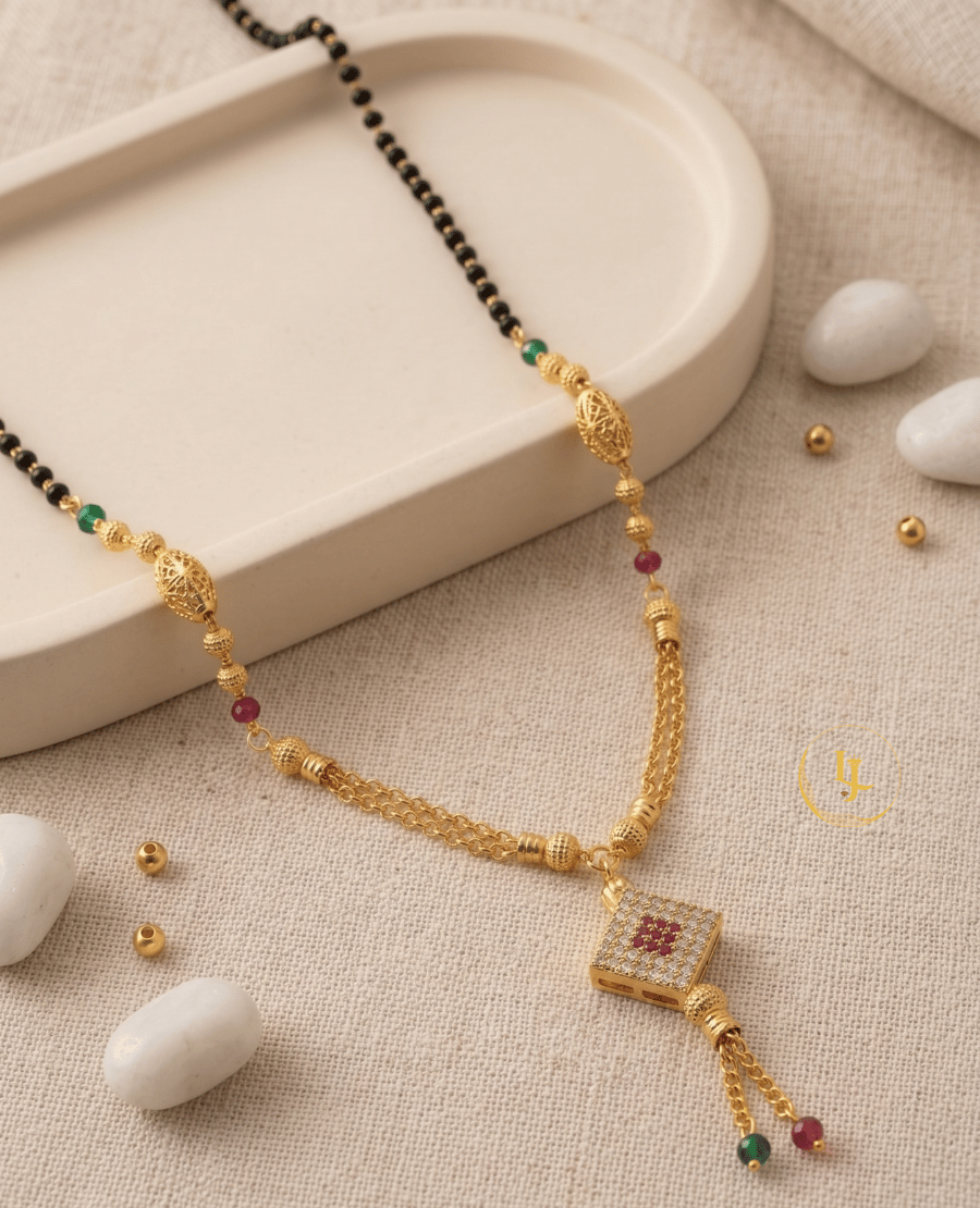 landmark-jewels-gold-plated-mangalsutra-with-a-square-diamond-studded-pendant-ruby-and-emerald-beads-filigree-gold-globes-and-a-double-chain-tassel-finish