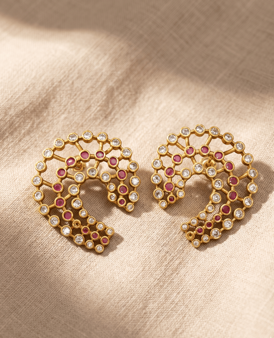 contemporary-gold-open-c-shaped-lattice-earrings-adorned-with-small-round-ruby-pink-stones-and-white-stones-arranged-in-concentric-rows