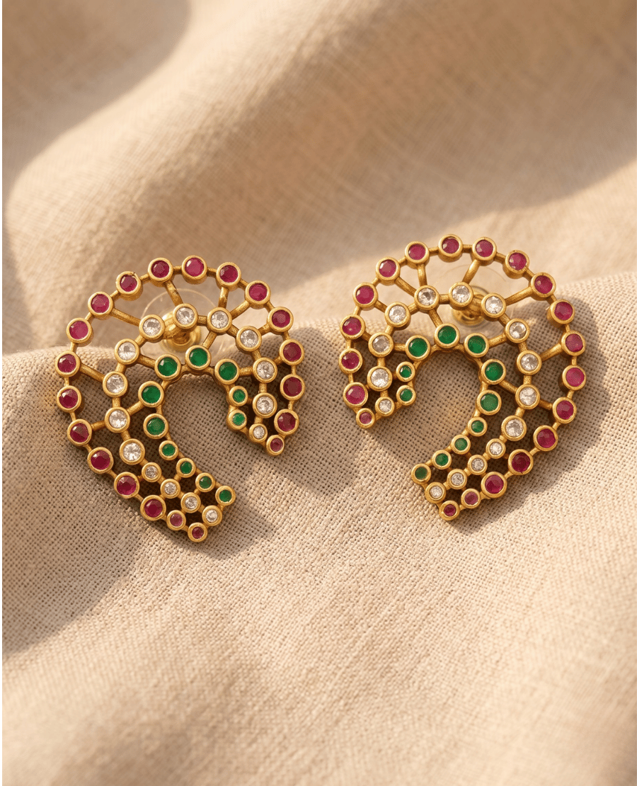 unique-gold-plated-crescent-horseshoe-earrings-by-landmark-jewels-set-with-rows-of-red-green-and-clear-stones-on-textured-linen-fabric