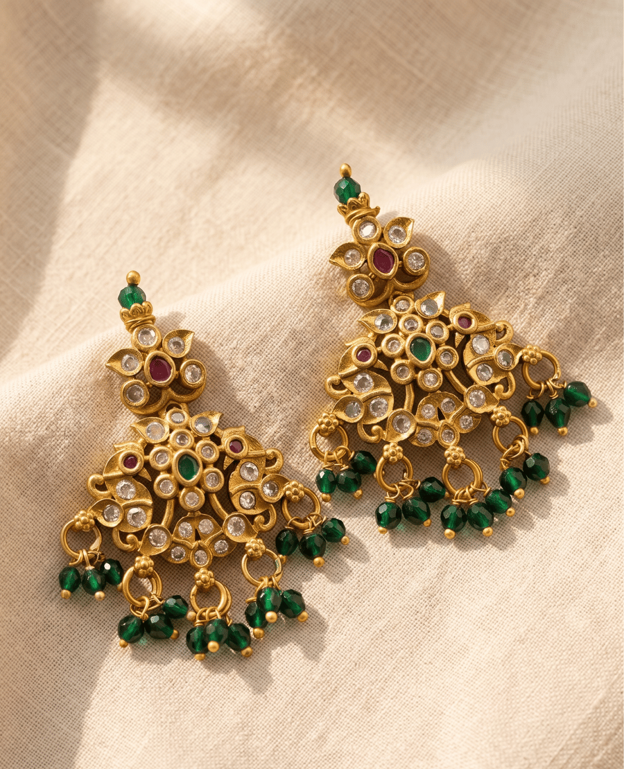intricate-antique-gold-plated-chandelier-earrings-decorated-with-clear-white-crystals-small-red-stones-and-multi-layered-emerald-green-faceted-bead-dangles