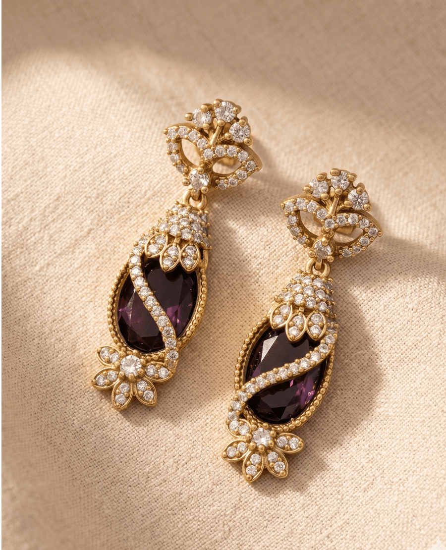 elegant-long-drop-earrings-by-landmark-jewels-featuring-dark-purple-oval-stones-wrapped-in-crystal-encrusted-gold-ribbons