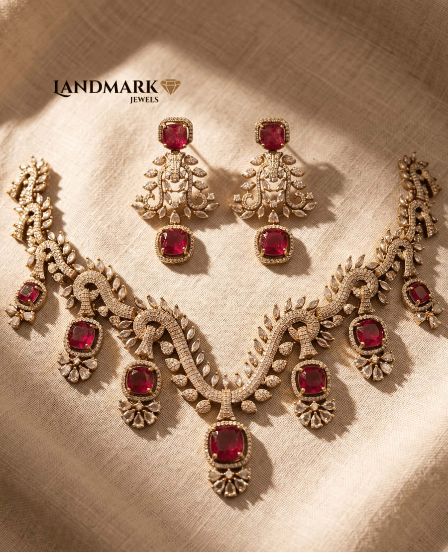 landmark-jewels-ruby-red-and-american-diamond-gold-toned-choker-necklace-with-matching-drop-earrings-on-a-neutral-fabric-background
