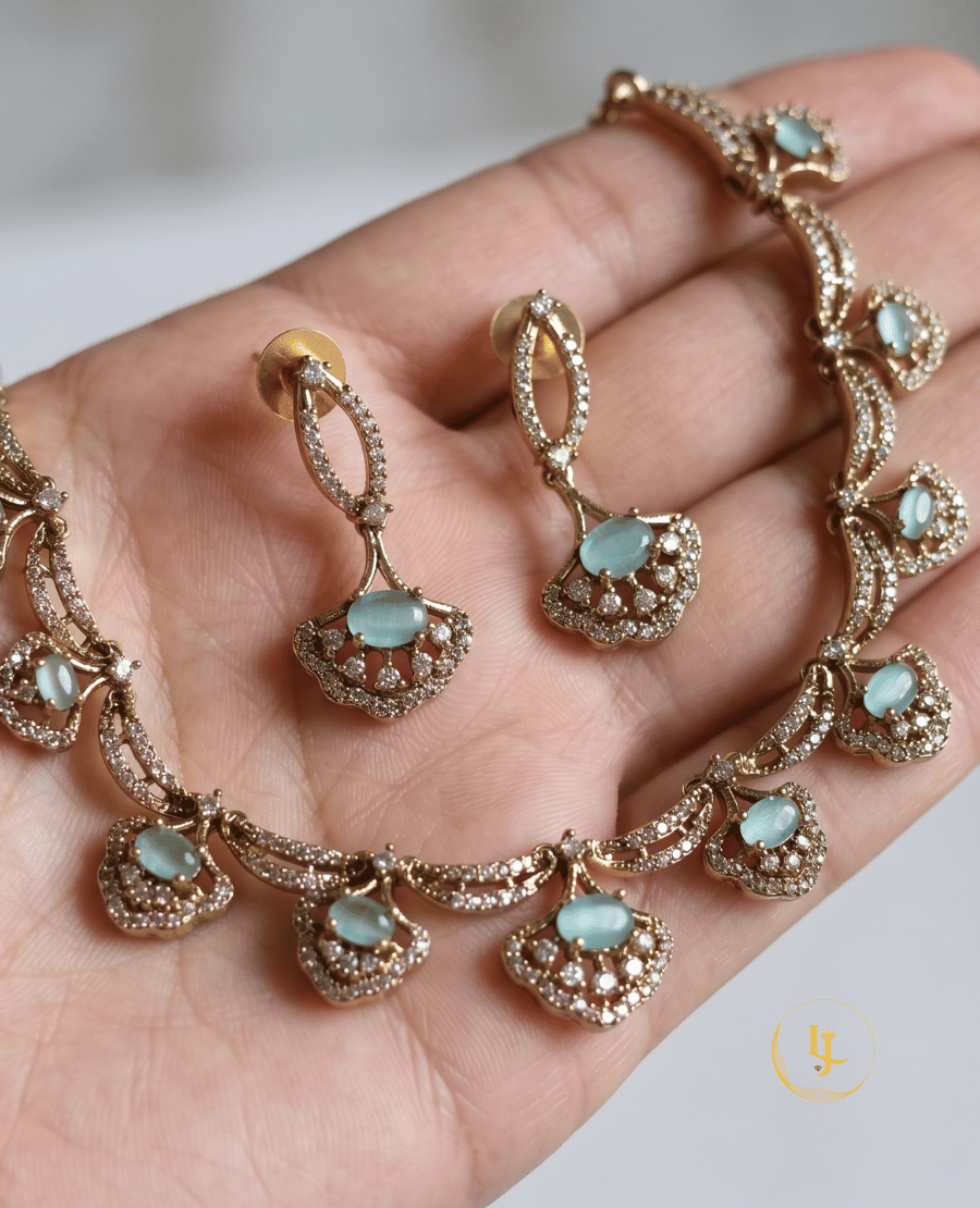 a-detailed-close-up-of-the-aura-choker-and-earring-set-held-in-hand-to-showcase-the-intricate-stone-placement-and-rose-gold-craftsmanship