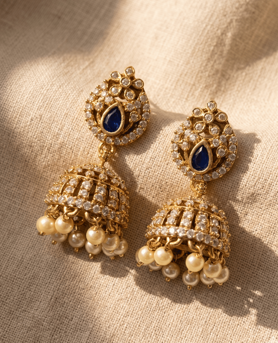 landmark-jewels-traditional-indian-jhumka-earrings-in-antique-gold-featuring-a-blue-stone-stud-and-crystal-dome-with-dangling-pearls