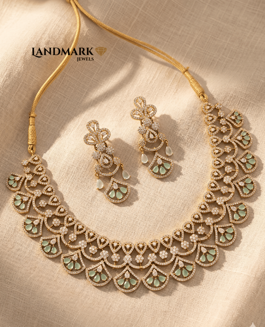 landmark-jewels-mint-green-and-cubic-zirconia-floral-scallop-necklace-set-with-matching-long-drop-earrings-on-a-beige-fabric-background