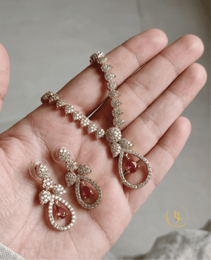 Landmark Jewels ruby and diamond necklace set held in hand to show the scale and craftsmanship.