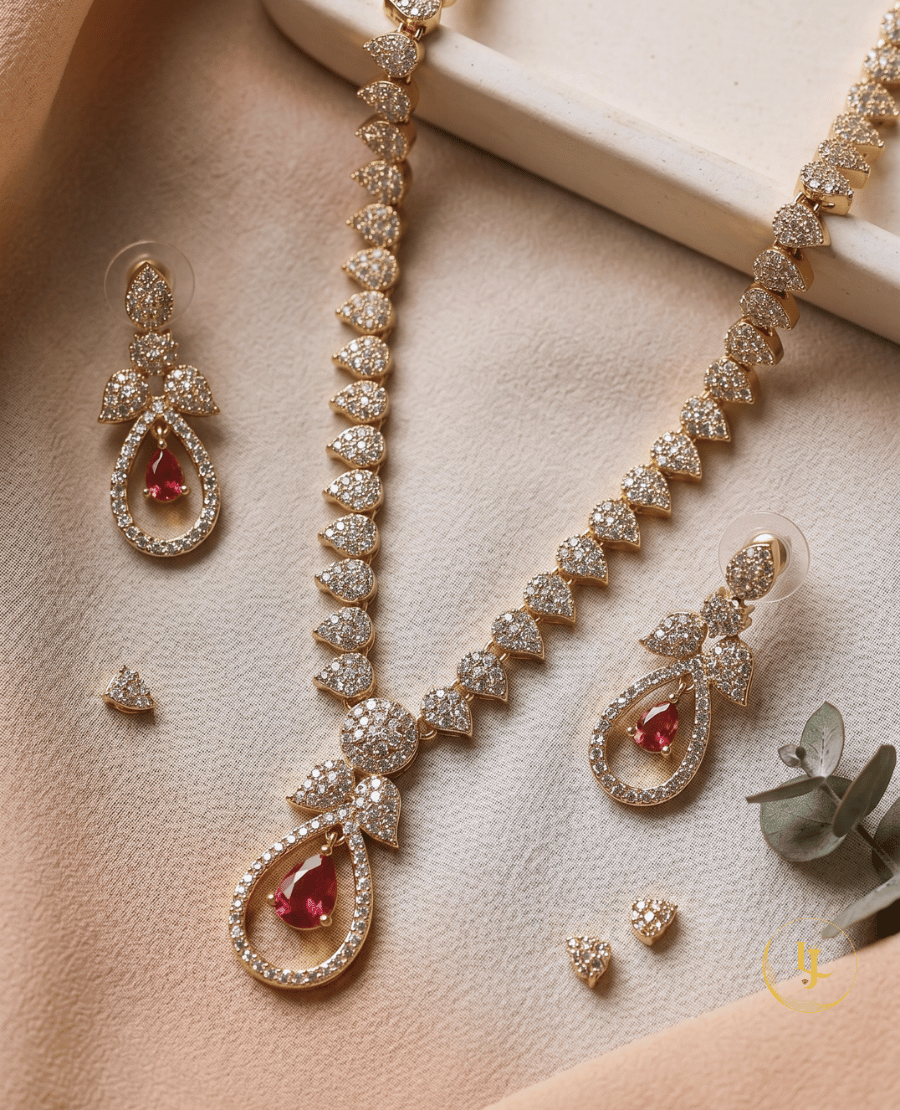 high-resolution-flat-lay-of-the-rose-gold-cz-diamond-necklace-and-earring-set-with-ruby-accents-on-a-beige-fabric-background