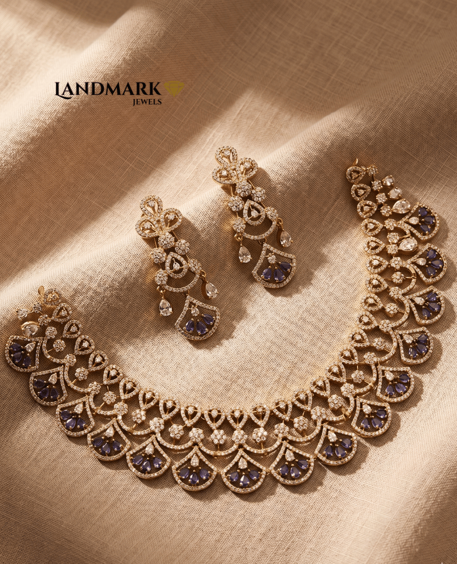 landmark-jewels-american-diamond-necklace-set-featuring-scalloped-floral-patterns-and-sapphire-blue-teardrop-stones-on-a-gold-toned-base