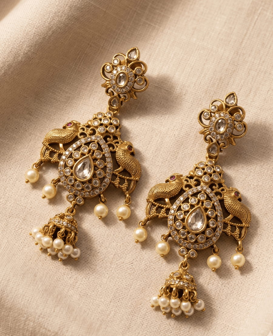 heavy-statement-antique-gold-earrings-featuring-dual-peacock-motifs-a-large-center-teardrop-stone-hanging-pearl-beads-and-a-small-central-dangling-jhumka