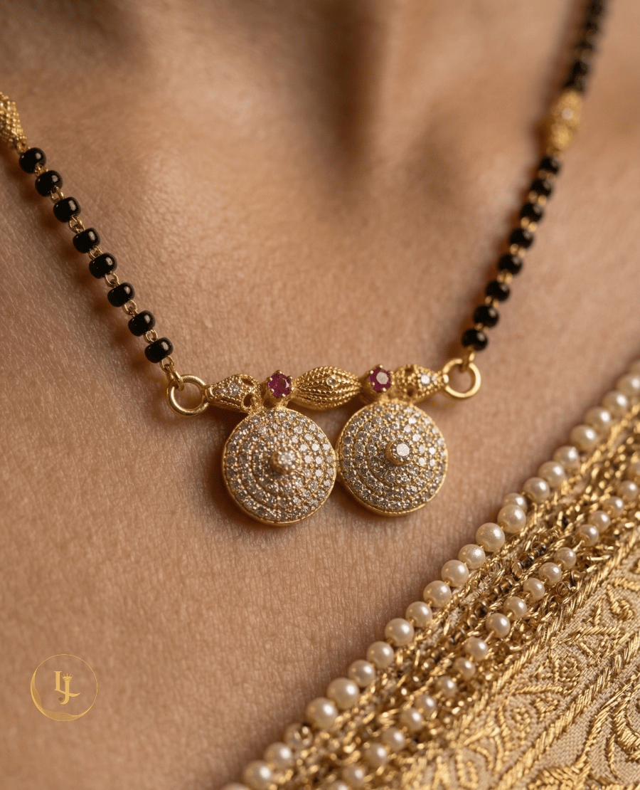 landmark-jewels-traditional-gold-plated-mangalsutra-with-black-beads-and-dual-diamond-studded-circular-pendant-on-a-beige-floral-background