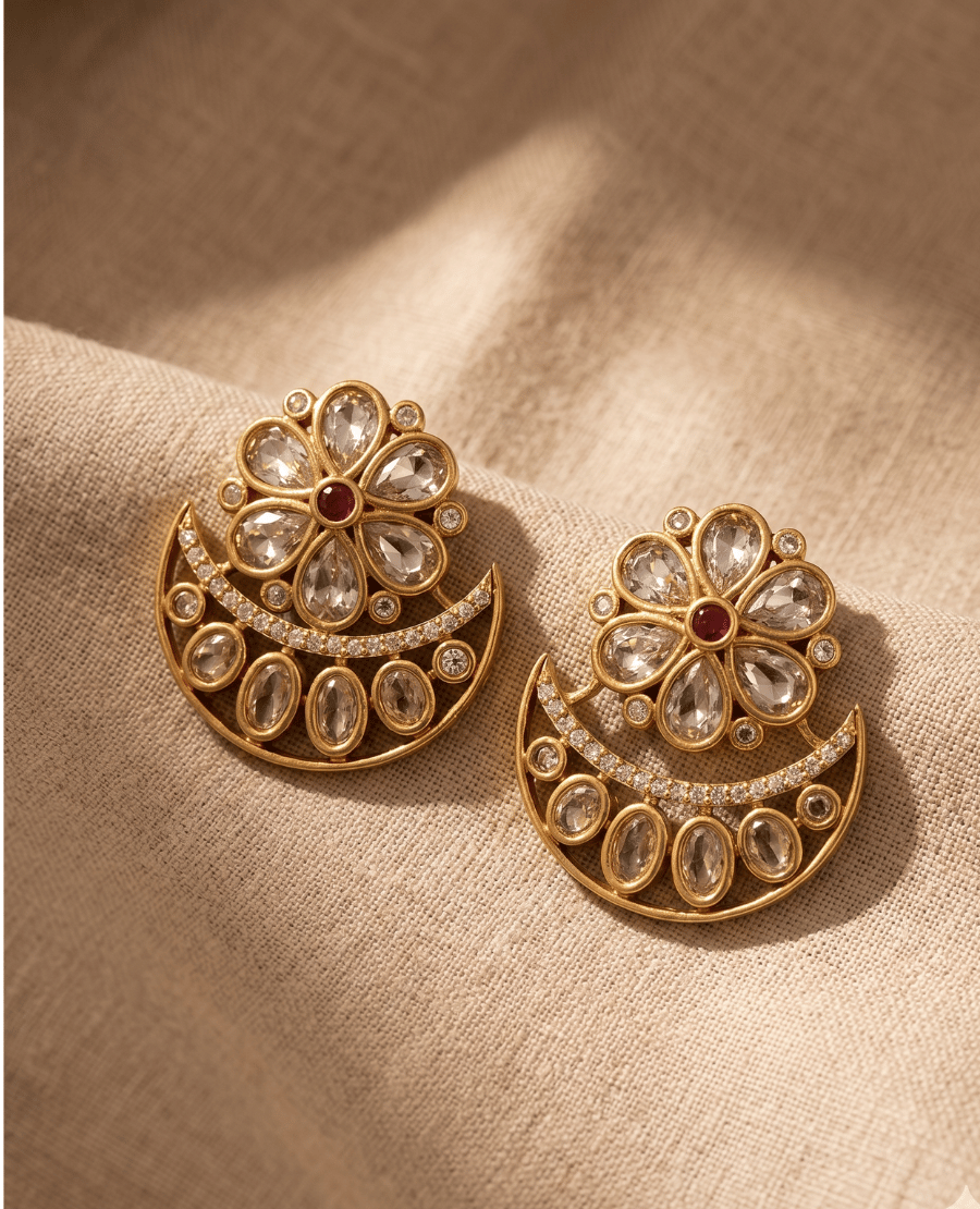 landmark-jewels-antique-gold-stud-earrings-designed-with-a-kundan-stone-flower-and-an-attached-crescent-moon-shape-on-textured-fabric