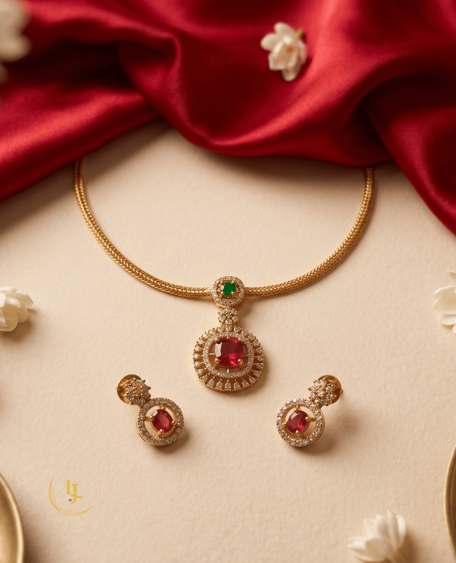 flat-lay-view-of-landmark-jewels-ruby-red-circular-pendant-set-with-gold-wheat-chain-on-a-cream-background