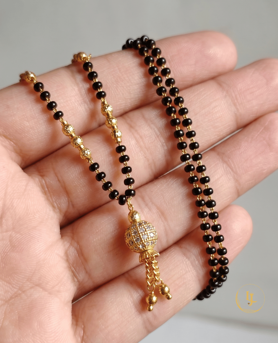 landmark-jewels-modern-gold-plated-mangalsutra-featuring-a-stone-studded-globe-pendant-with-gold-tassels-and-a-delicate-black-bead-chain