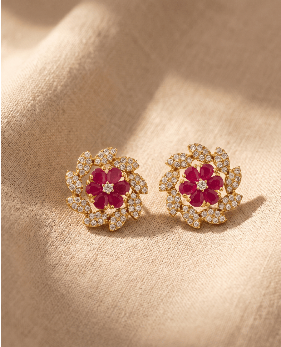 shimmering-gold-stud-earrings-by-landmark-jewels-featuring-a-red-crystal-flower-center-surrounded-by-a-swirl-of-clear-cz-stones