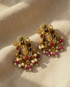 Antique gold-finished temple earrings featuring colorful cabochon stones and dangling pearls.