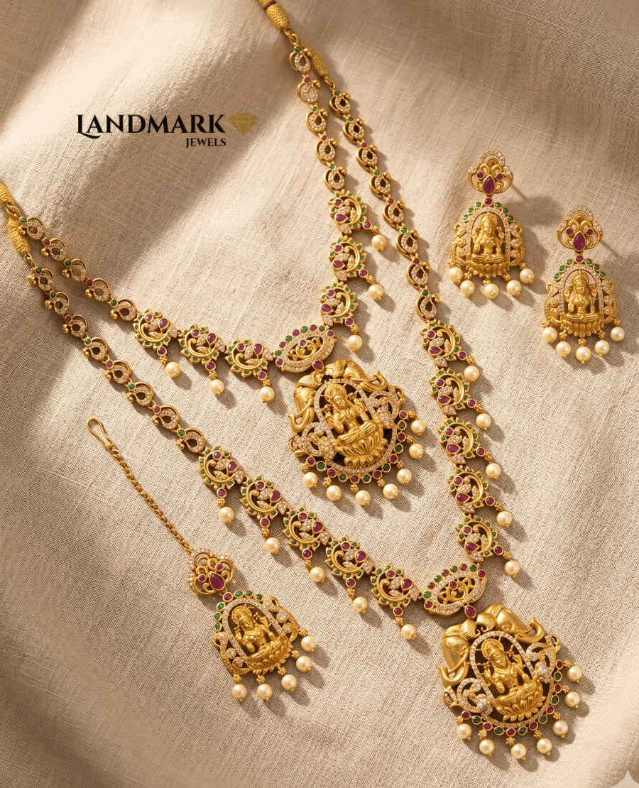 landmark-jewels-antique-gold-plated-lakshmi-temple-jewellery-set-including-long-necklace-earrings-and-maang-tikka-with-ruby-and-green-stone-embellishments