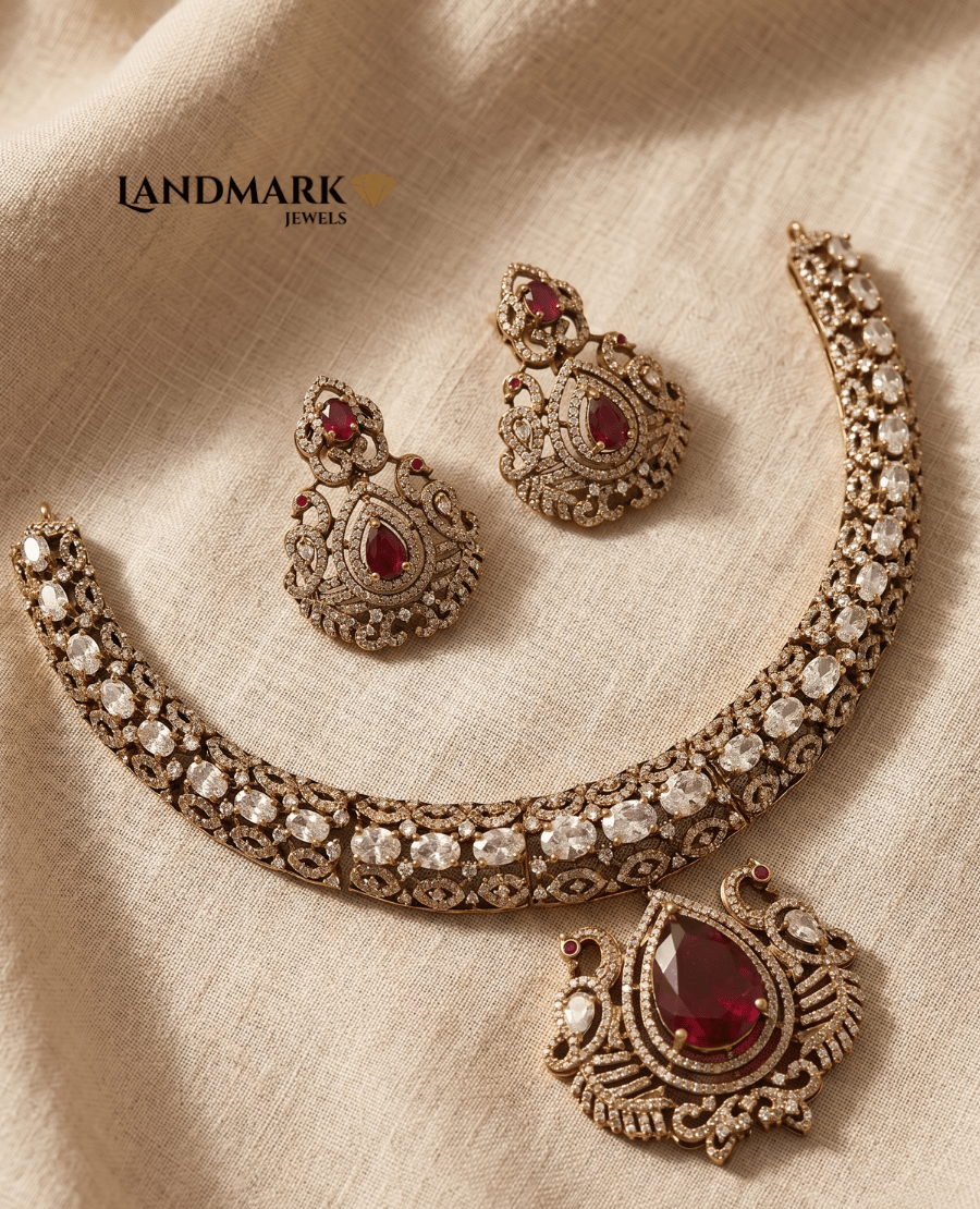 landmark-jewels-antique-gold-plated-choker-necklace-and-earring-set-featuring-peacock-motifs-ruby-red-teardrop-stones-and-white-zircons-on-a-beige-linen-background