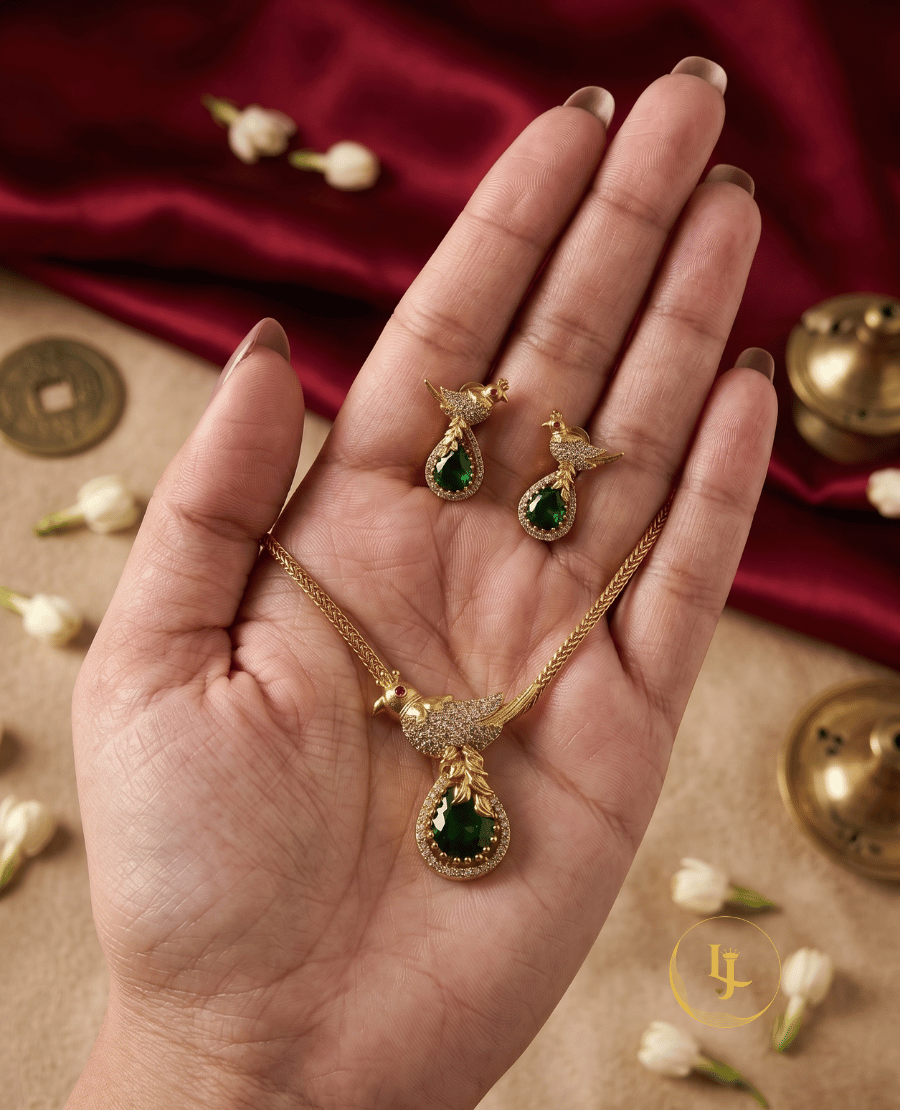 close-up-of-the-landmark-jewels-gold-plated-bird-pendant-set-and-earrings-held-in-hand-to-show-scale-and-detail