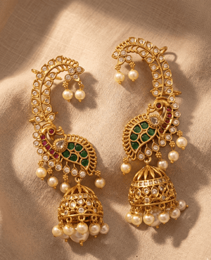Grand Landmark Jewels traditional Indian ear cuffs featuring green and red enamel peacock designs and hanging gold jhumka domes with pearls