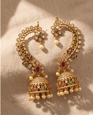 Elegant traditional Indian gold ear cuffs (Kan Seri) by Landmark Jewels featuring a long curved paisley vine motif leading down to a pearl-drop Jhumka.