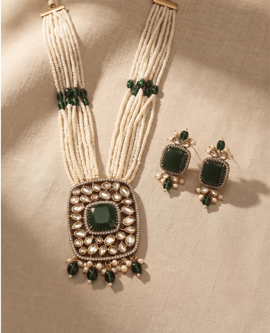 multi-strand-white-seed-bead-necklace-with-a-large-rectangular-pendant-featuring-a-central-green-stone-and-polki-work-alongside-matching-earrings