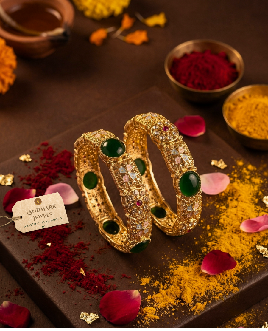 antique-gold-plated-bangles-with-emerald-green-stones-and-floral-meenakari-design-on-a-traditional-festive-background