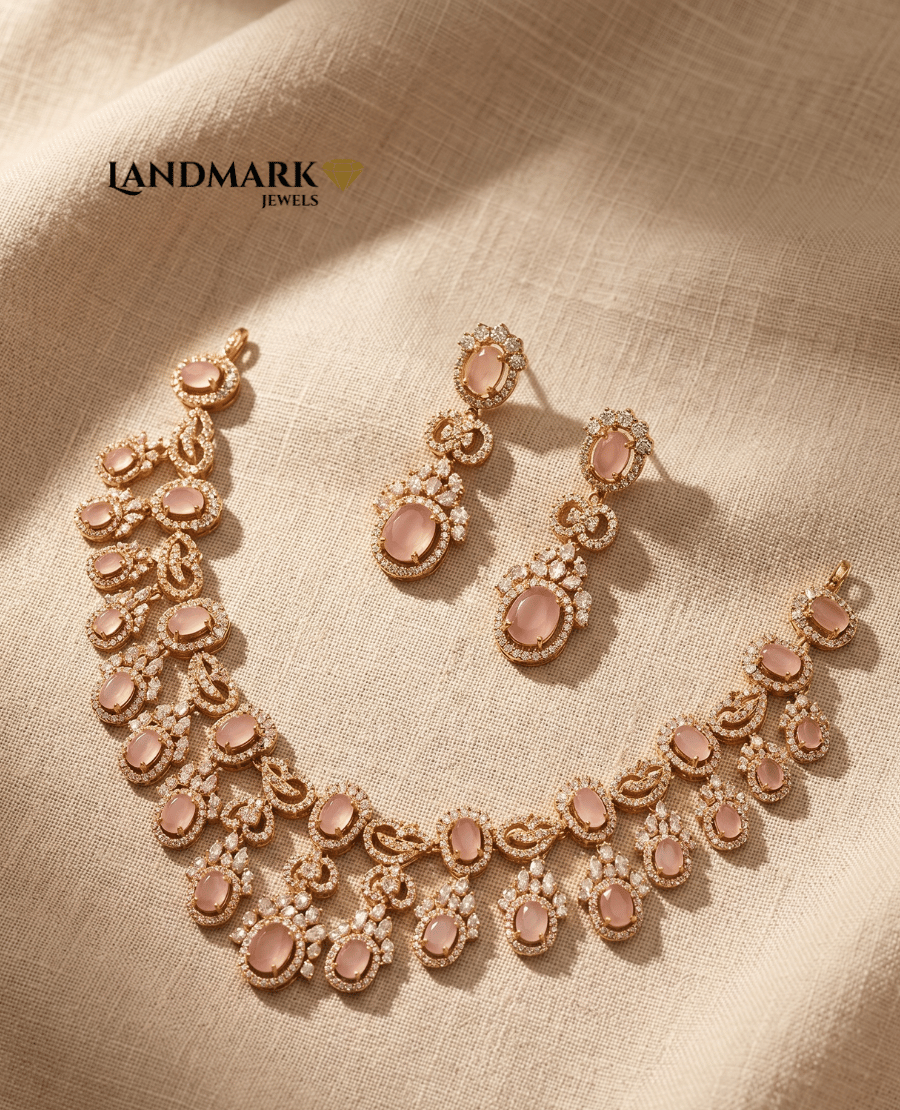 elegant-landmark-jewels-imitation-jewelry-set-featuring-a-rose-gold-plated-necklace-and-drop-earrings-adorned-with-oval-blush-pink-stones-and-sparkling-white-american-diamonds-on-a-beige-fabric-background