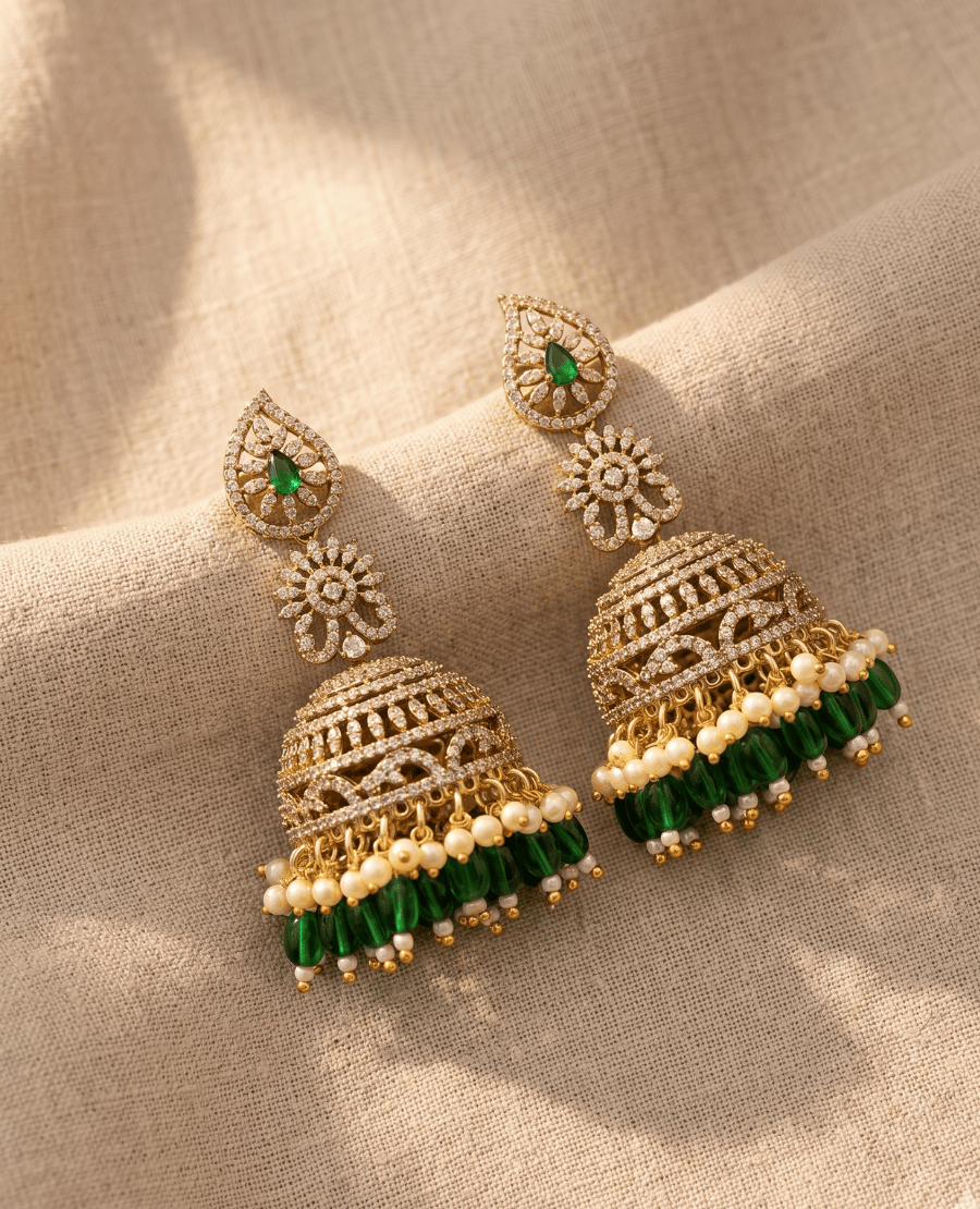 pair-of-traditional-heavy-gold-plated-dome-shaped-jhumka-earrings-by-landmark-jewels-with-a-floral-stud-brilliant-crystal-tiers-and-a-dense-fringe-of-white-pearls-and-green-hanging-beads