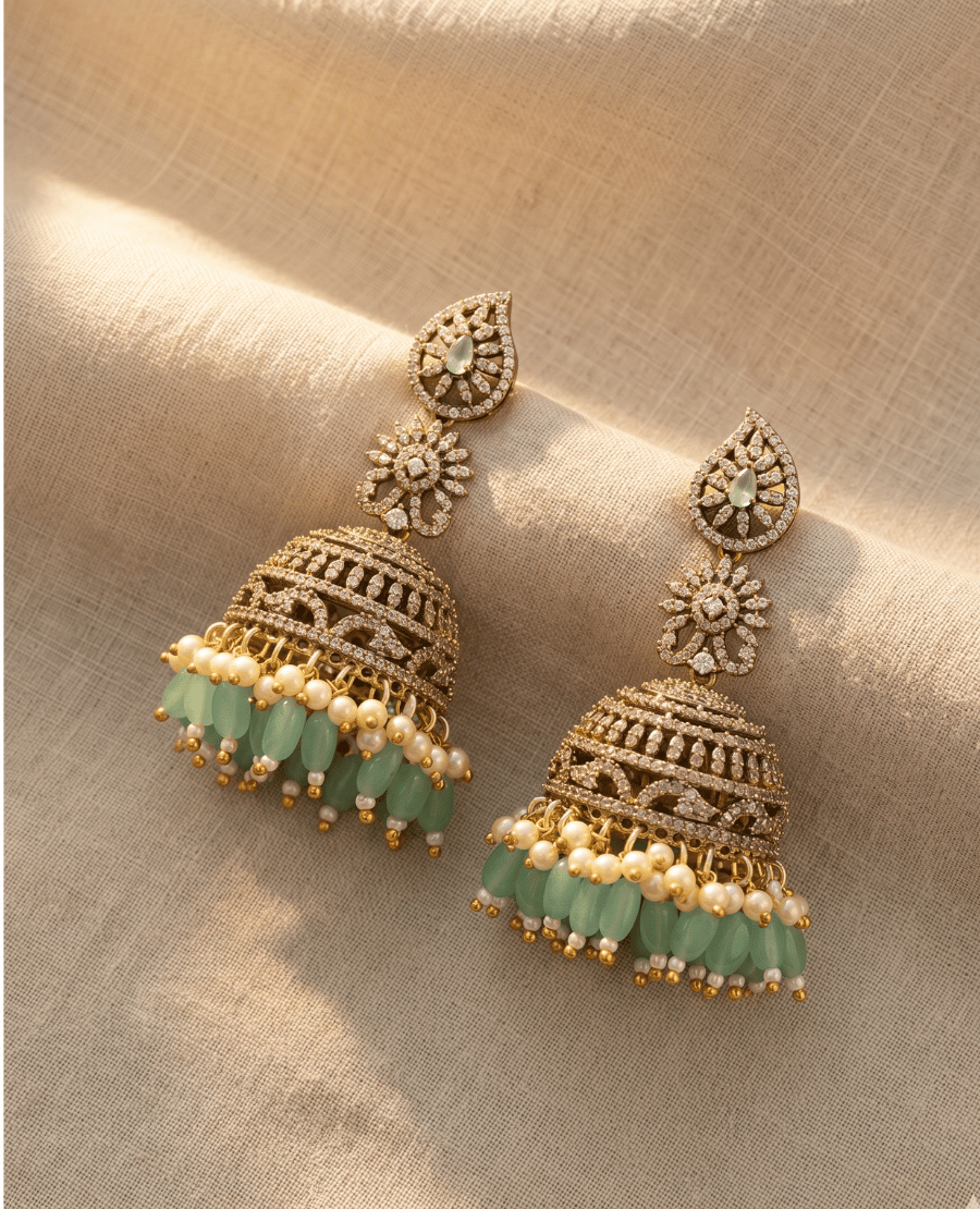 heavy-bridal-style-gold-plated-jhumka-earrings-featuring-intricate-cz-filigree-work-and-a-dangling-row-of-mint-green-oval-beads-and-pearls