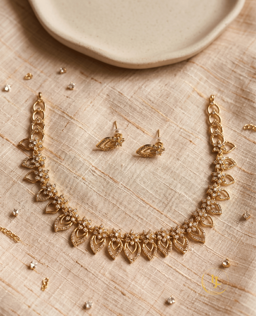 overhead-shot-of-the-complete-landmark-jewels-jewelry-set-including-the-necklace-and-earrings-laid-out-on-a-textured-cream-fabric-background