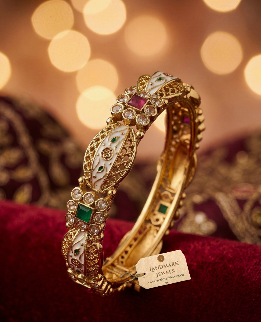 pair-of-gold-plated-indian-kada-bangles-with-mint-green-and-pink-stones-and-white-enamel-meenakari-work-on-a-silk-background