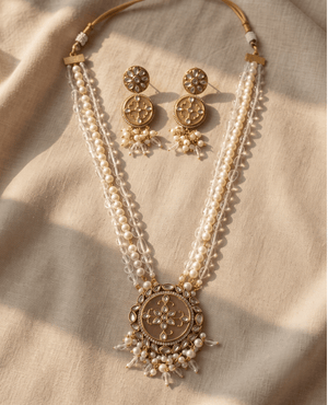 Long multi-strand pearl and crystal bead necklace with an ornate round gold pendant and matching circular floral studs.