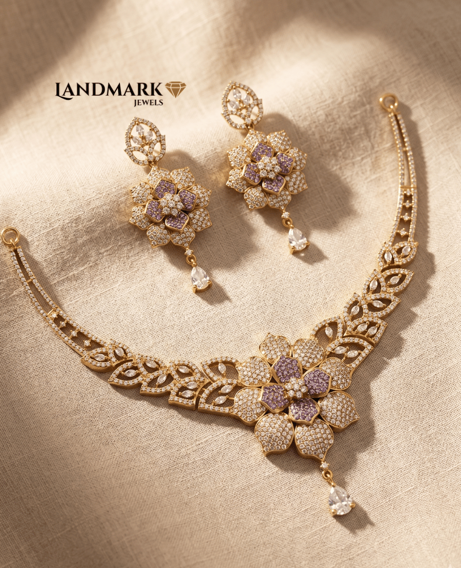a-beautiful-gold-toned-jewelry-set-from-landmark-jewels-featuring-a-necklace-and-matching-earrings-with-intricate-floral-designs-amethyst-colored-stones-and-sparkling-white-cubic-zirconia