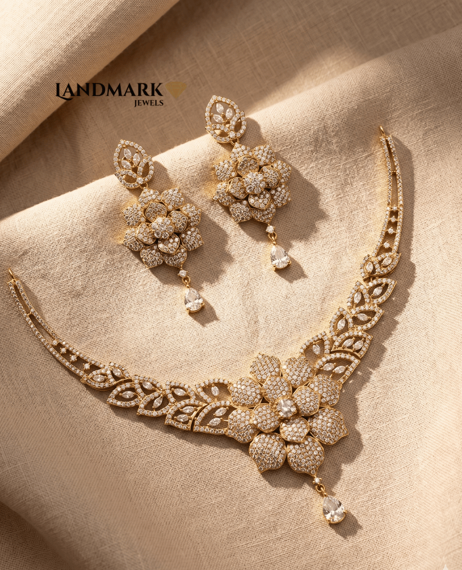 landmark-jewels-gold-plated-necklace-and-earring-set-featuring-a-large-central-flower-motif-encrusted-with-white-cubic-zirconia-stones-on-a-beige-fabric-background
