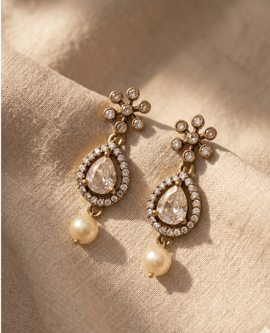 landmark-jewels-vintage-style-gold-earrings-with-a-small-star-floral-stud-a-large-teardrop-crystal-charm-with-a-pave-border-and-a-dangling-round-ivory-pearl