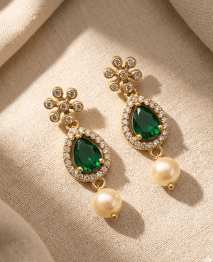 A pair of gold-plated drop earrings from Landmark Jewels featuring a floral CZ top, pear-shaped green emerald stone surrounded by crystals, and a bottom pearl bead.
