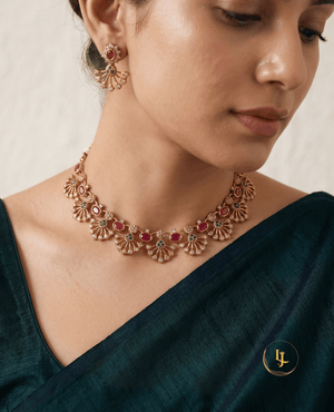 Close-up of a model wearing the Landmark Jewels Gulnar necklace and earrings with a dark teal silk saree.