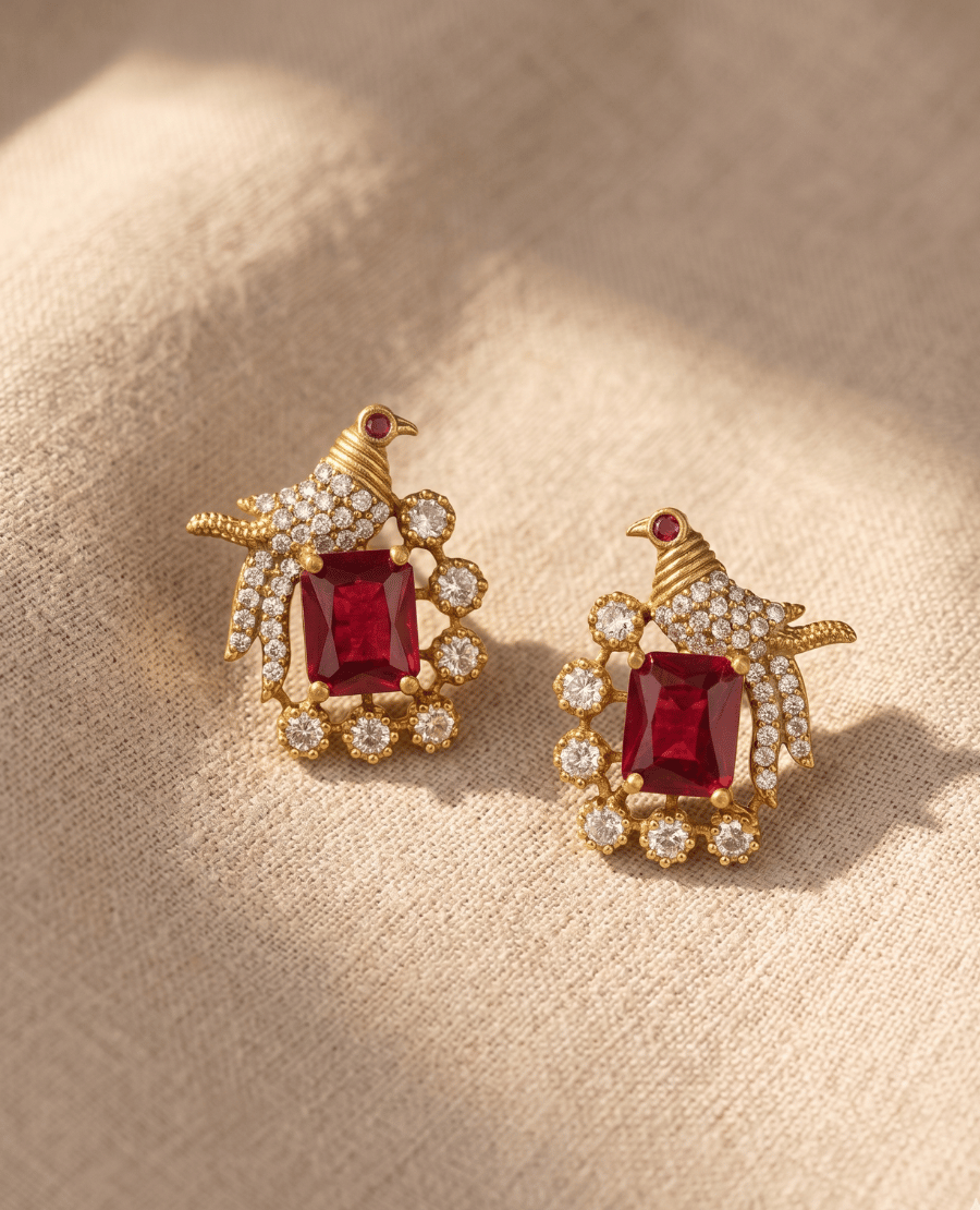 pair-of-gold-plated-bird-motif-stud-earrings-with-a-large-emerald-cut-red-ruby-gemstone-and-cubic-zirconia-details-by-landmark-jewels