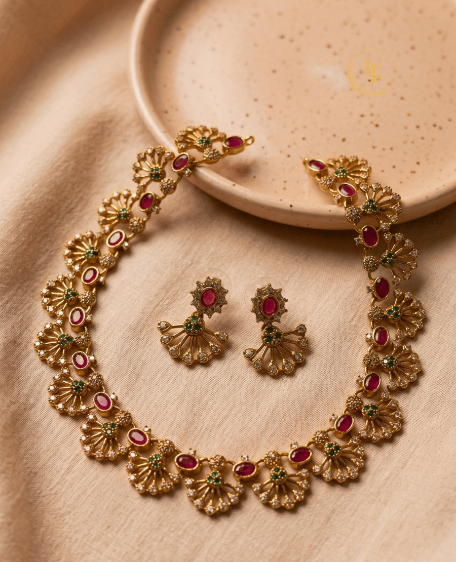 top-down-flatlay-of-the-ruby-and-emerald-imitation-necklace-set-on-a-beige-fabric-background-with-a-ceramic-plate