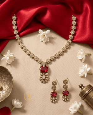 Overhead view of the Landmark Jewels floral ruby necklace set styled with jasmine flowers and traditional brass decor.