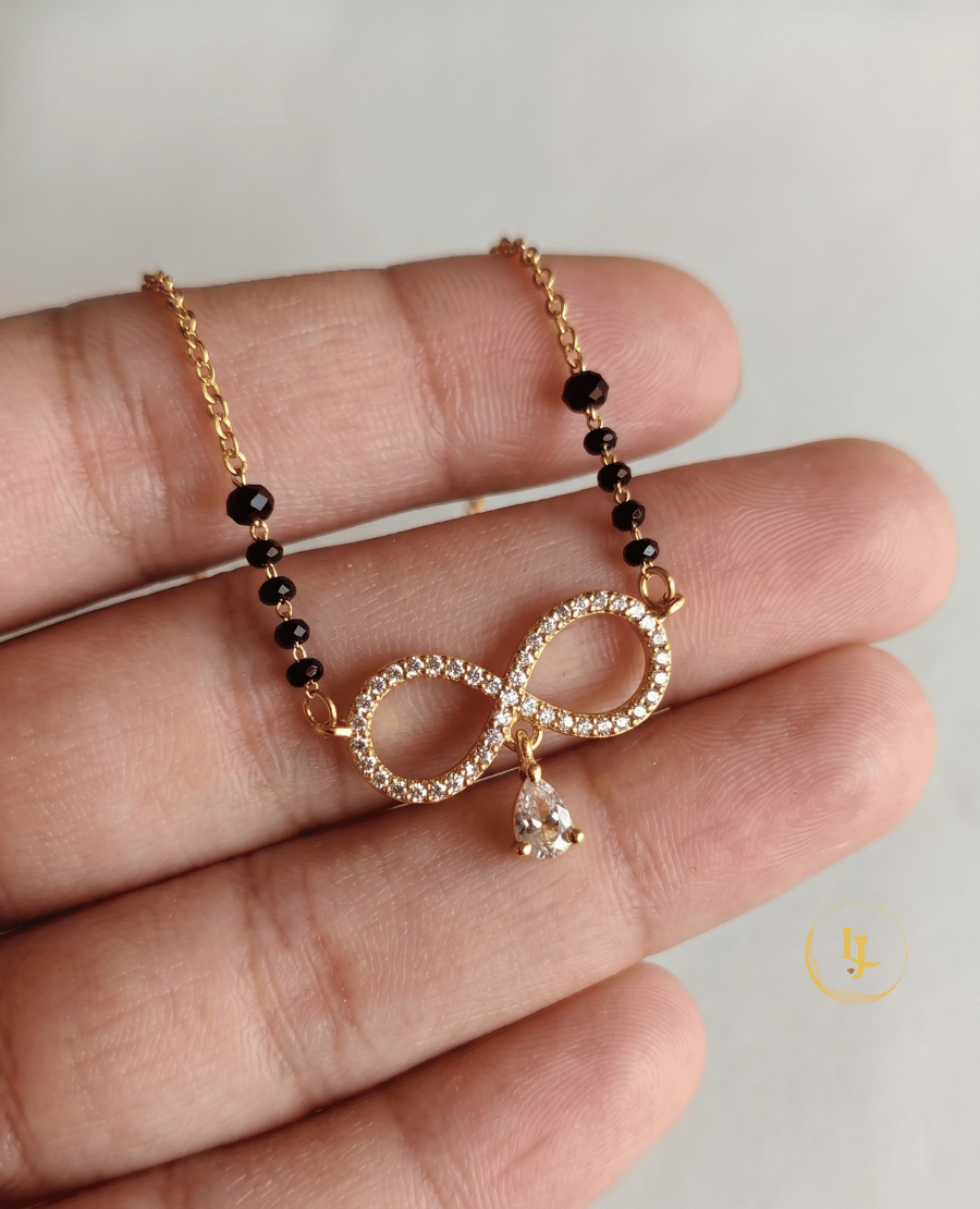 landmark-jewels-gold-plated-mangalsutra-featuring-an-infinity-shaped-pendant-with-american-diamonds-and-a-hanging-pear-cut-stone-on-a-designer-black-bead-chain