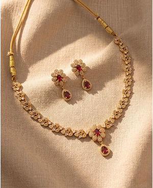 Gold plated ruby red American diamond floral leaf necklace set with matching drop earrings