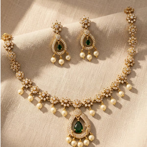 Gold plated American diamond floral necklace with green teardrop pendant pearl drops and matching earrings
