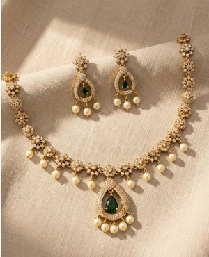 Gold plated American diamond floral necklace with green teardrop pendant pearl drops and matching earrings