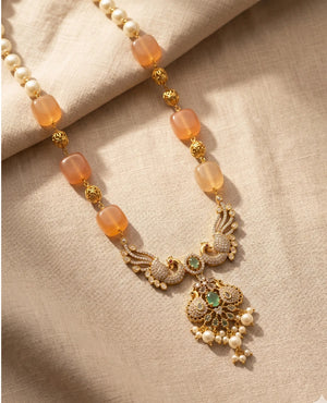 Antique gold peacock pendant necklace with peach beads pearls and green stone