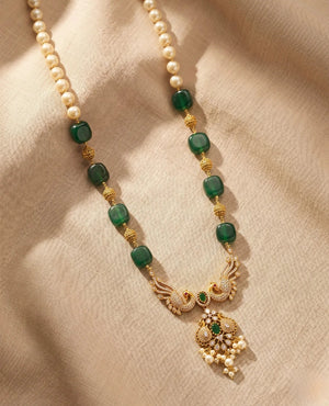 Long antique gold haar necklace with green beads, pearls and peacock pendant with CZ stones