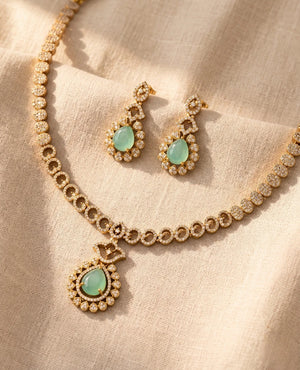 Gold plated necklace set with mint green teardrop stone and American diamonds with matching earrings